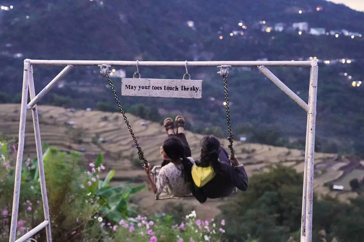 Children play at 'Mosen Viewpoint' in Kigwema village, in the northeastern Indian state of Nagaland, Tuesday, Oct. 27, 2026. (AP Photo/Yirmiyan Arthur)