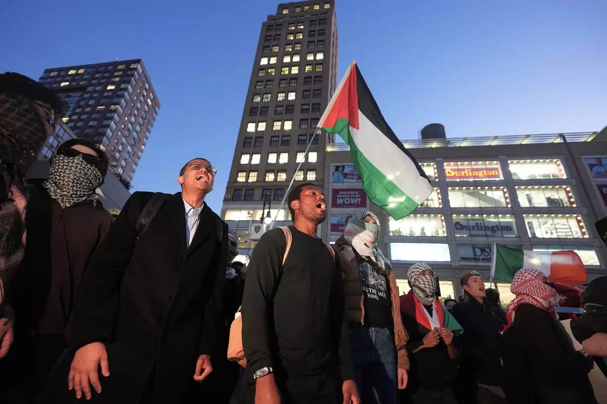 Protesters gather near a vigil marking the third anniversary of the October 7 attacks on Israel Wednesday, Oct. 7, 2026, in New York. (AP Photo/Frank Franklin II)