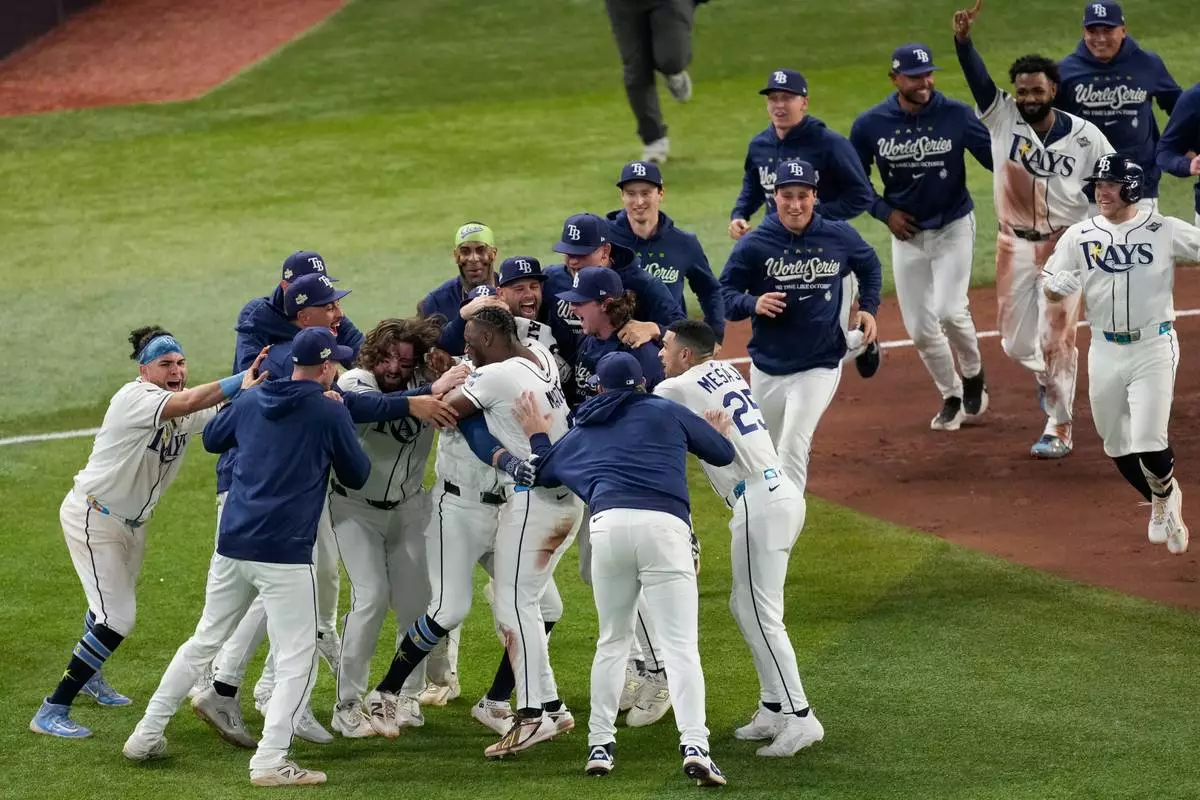 The Tampa Bay Rays celebrate their win after the 12th inning of Game 4 of baseball's World Series, Wednesday, Oct. 28, 2026, in St. Petersburg, Fla., between the Milwaukee Brewers and the Tampa Bay Rays. (AP Photo/Morry Gash)