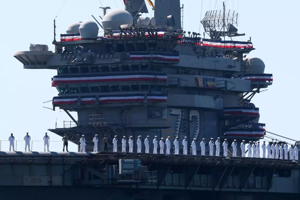 The USS Abraham Lincoln aircraft carrier returns to the San Diego Bay after deployment Thursday, Oct. 8, 2026, in San Diego. (AP Photo/Karl Anderson)