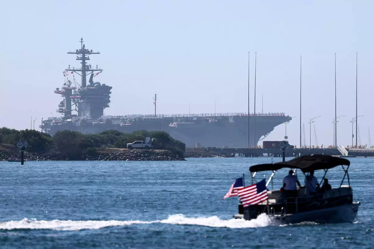 The USS Abraham Lincoln aircraft carrier returns to the San Diego Bay after deployment Thursday, Oct. 8, 2026, in San Diego. (AP Photo/Karl Anderson)