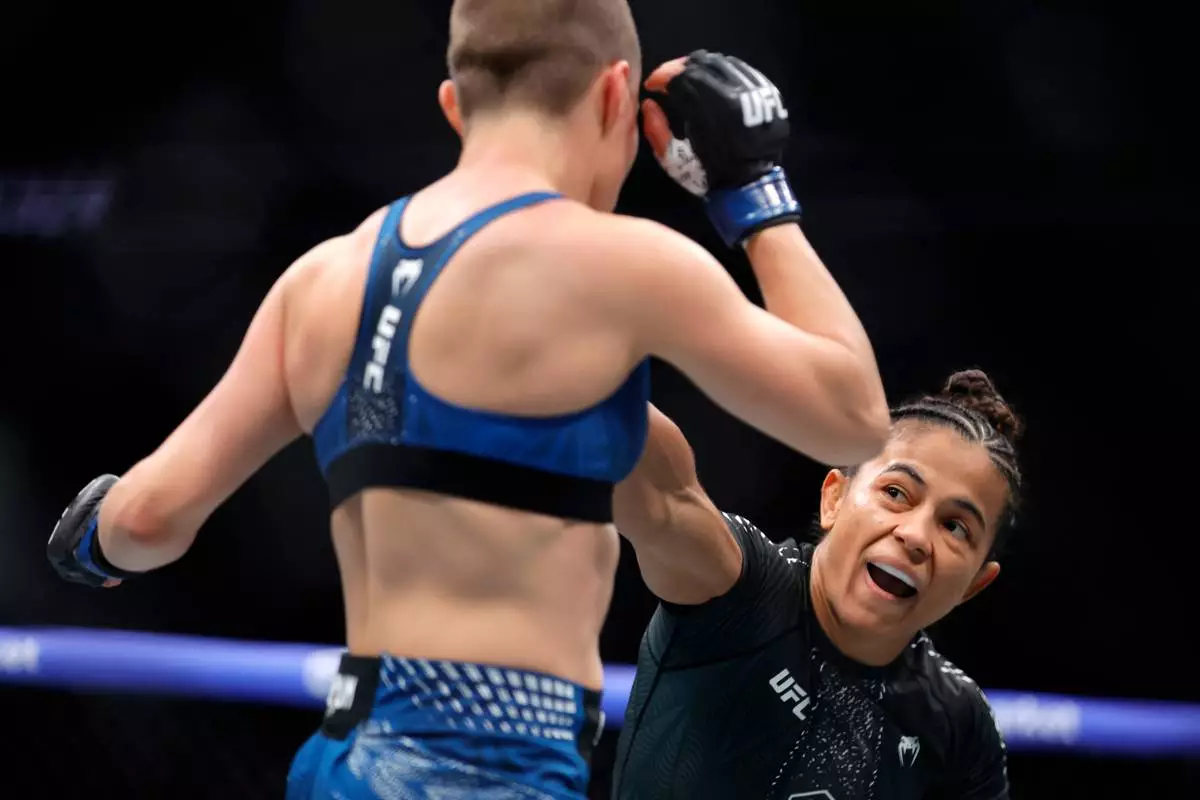 FILE - Natalia Silva, right, punches Rose Namajunas in a women's flyweight bout during the UFC 324 mixed martial arts event Saturday Jan. 24, 2026, in Las Vegas. (AP Photo/Steve Marcus, File)