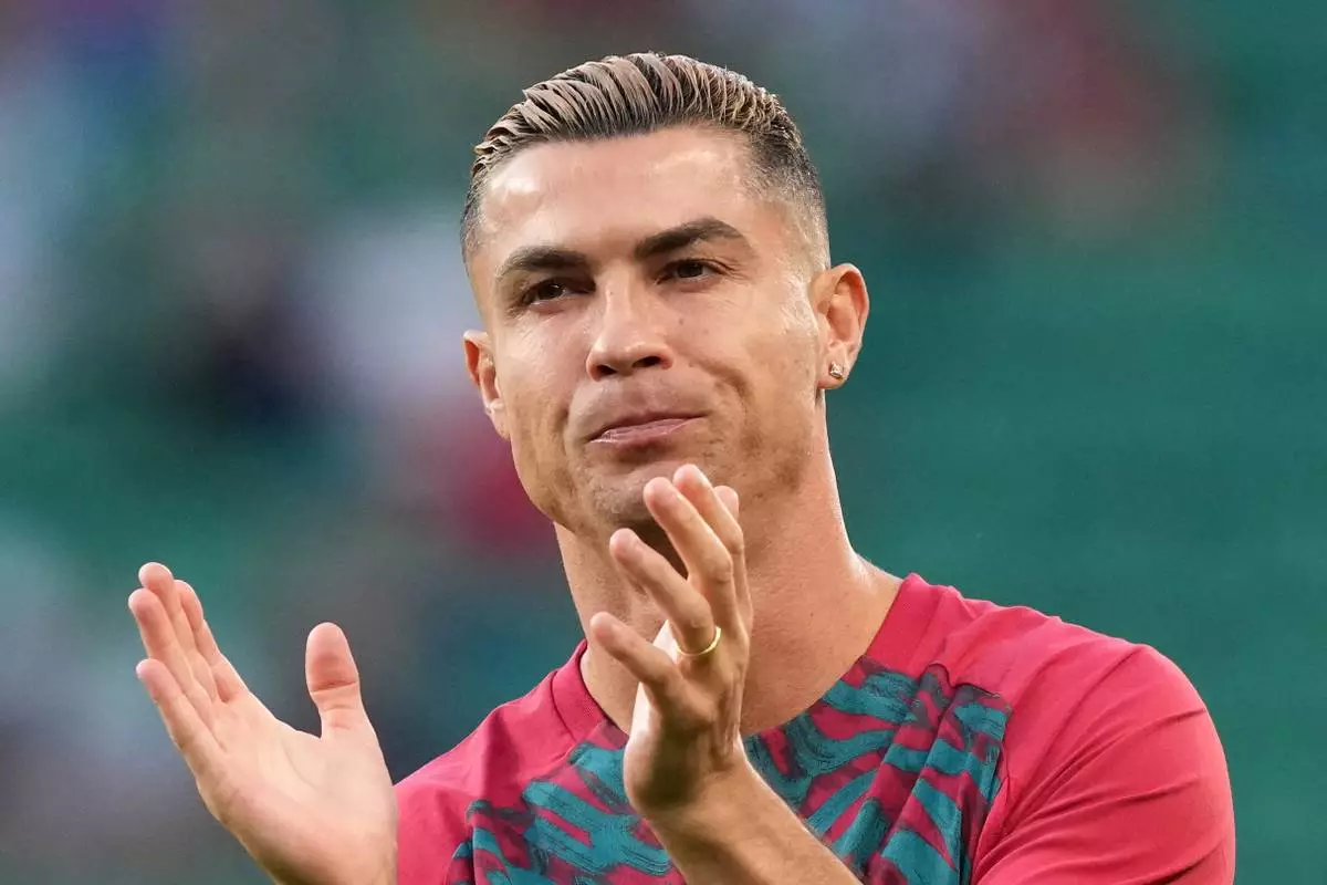 Portugal's Cristiano Ronaldo, wearing a wedding band, claps his hands during warmup before the Nations League soccer match between Portugal and Wales in Lisbon, Thursday, Sept. 24, 2026. (AP Photo/Armando Franca)