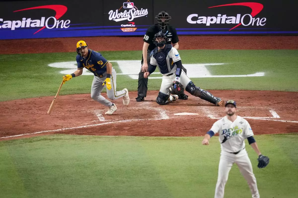 Milwaukee Brewers third baseman David Hamilton, left, Tampa Bay Rays catcher Nick Fortes, center, and pitcher Cole Sulser, right, watch his RBI base hit during the fifth inning of Game 3 of baseball's World Series, Monday, Oct. 26, 2026, in St. Petersburg, Fla., between the Milwaukee Brewers and the Tampa Bay Rays. (AP Photo/Morry Gash)