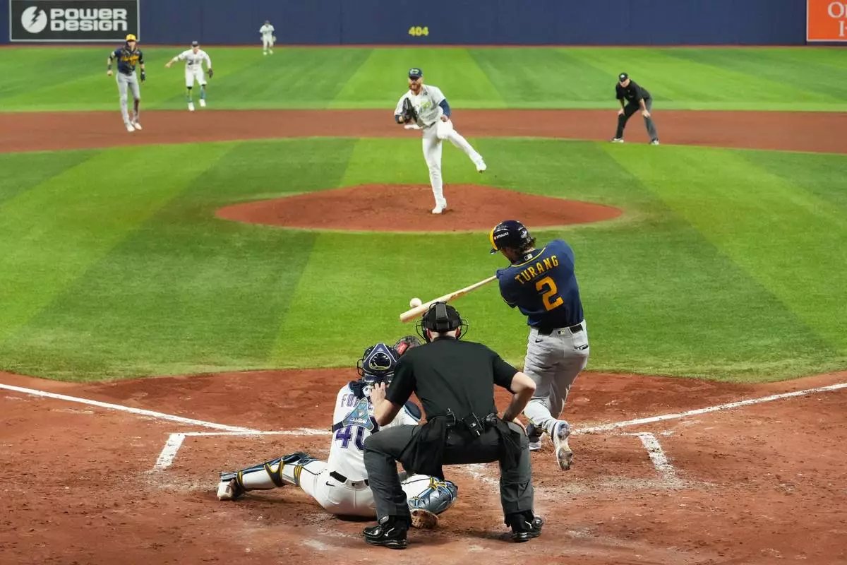 Milwaukee Brewers' Brice Turang hits two-run single during the fifth inning of Game 3 of baseball's World Series, Monday, Oct. 26, 2026, in St. Petersburg, Fla., between the Milwaukee Brewers and the Tampa Bay Rays. (AP Photo/Ashley Landis)