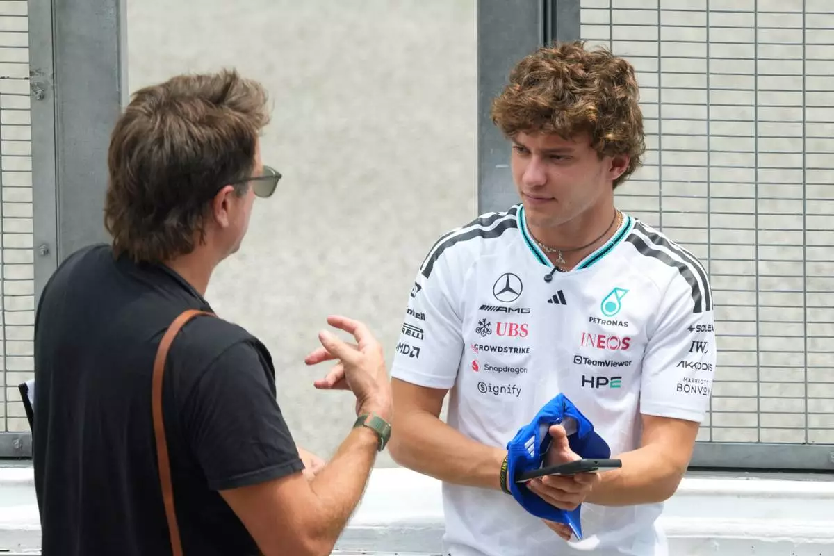 Mercedes driver Andrea Kimi Antonelli of Italy, right, at the pit wall ahead of the Bahrain Grand Prix in Malaysia at the Sepang International Circuit in Sepang, Malaysia, Thursday, Oct. 1, 2026. (AP Photo/Vincent Thian)
