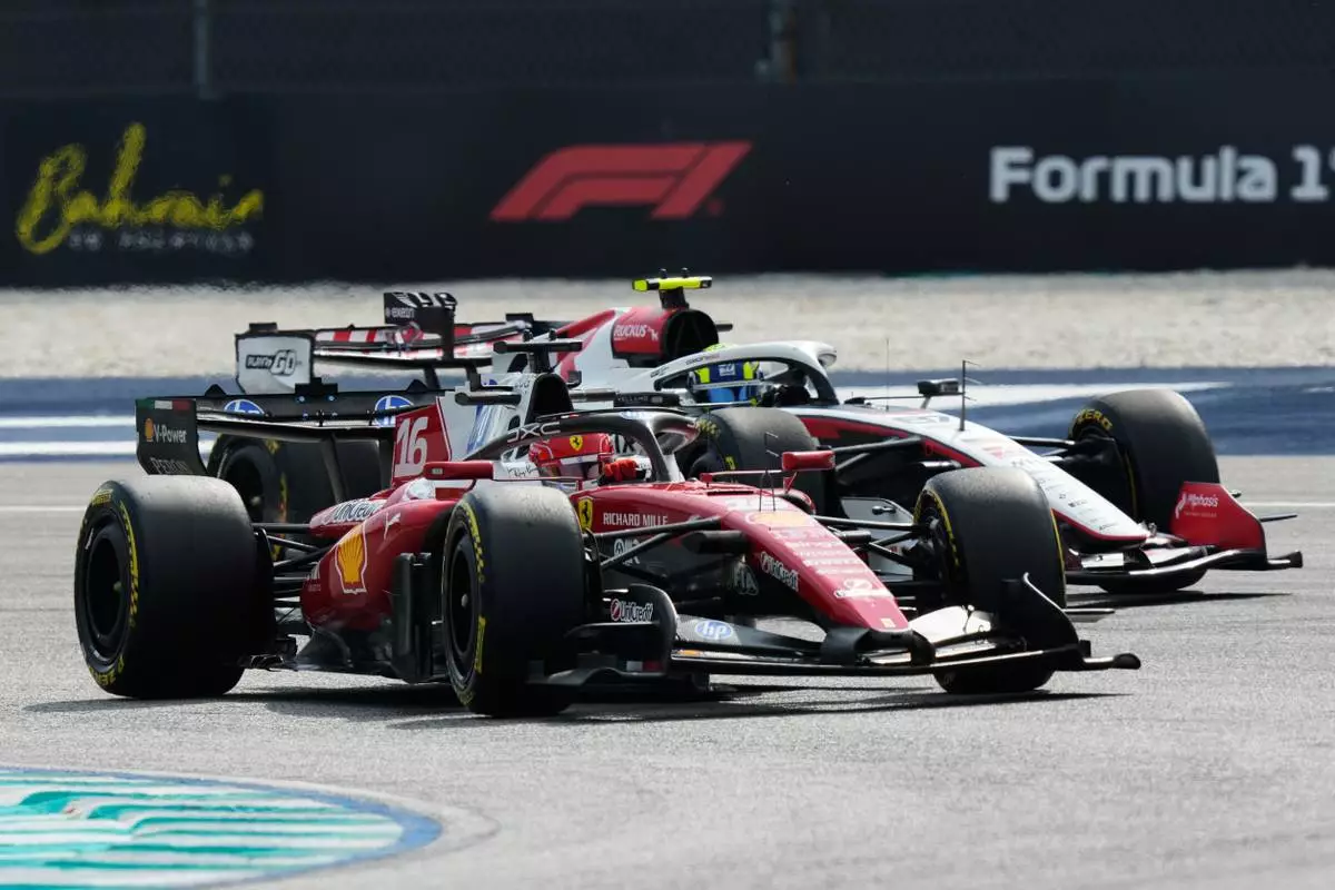 Ferrari driver Charles Leclerc of Monaco, front, and Haas driver Oliver Bearman of Britain steer their cars during the first free practice session ahead of the Bahrain Grand Prix in Sepang, Malaysia, Friday, Oct. 2, 2026. (AP Photo/Aijaz Rahi) CORRECTION: ID of driver corrected to Oliver Bearman instead of Lewis Hamilton