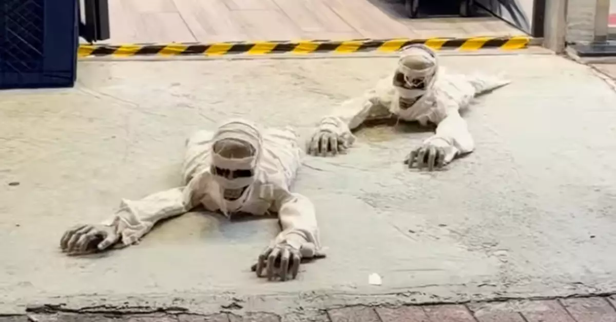Halloween Approaches with Spooky Shop Decorations: “Living Mummies” Crawl Along Quarry Bay Street