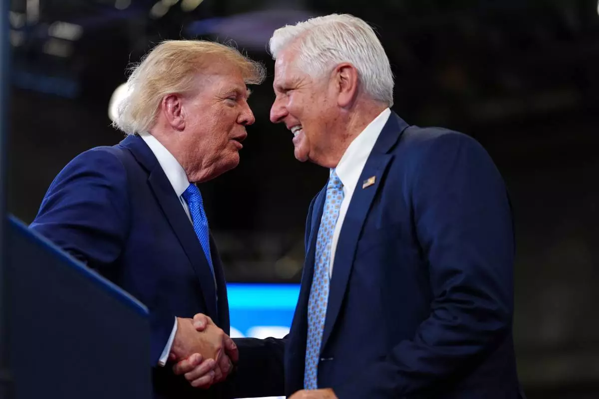 FILE - President Donald Trump, left, shakes the hand of Bruce Blakeman, the executive of Nassau County and Republican gubernatorial candidate for New York, during an event at the David Mack Center for Training and Intelligence, Aug. 14, 2026, in Garden City, N.Y. (AP Photo/Julia Demaree Nikhinson, File)