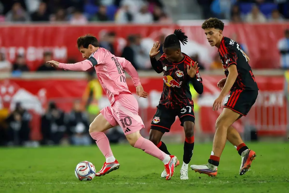 Inter Miami forward Lionel Messi, left, dribbles as New York Red Bulls forward Mohammed Sofo, center, and Adri Mehmeti defend during an MLS soccer match Saturday, Oct. 24, 2026, in Harrison, N.J. (AP Photo/Eduardo Munoz Alvarez)
