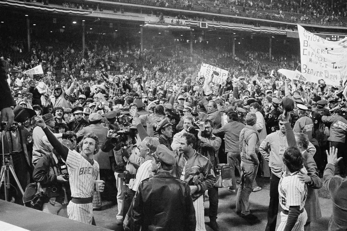 FILE - Milwaukee Brewers shortstop Robin Yount, left, waves to the crowd as they celebrate near the dugout in County Stadium, Milwaukee after Game 5 of the World Series, Oct. 17, 1982. (AP Photo, File)