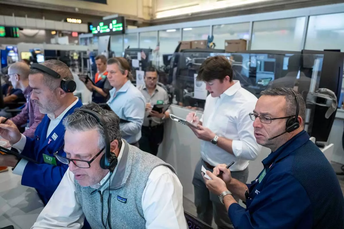 Options traders, including Marty Handler, foreground, and Matt Hefter, right, work on the floor of the New York Stock Exchange, Thursday, Oct. 8, 2026, in New York. (AP Photo/Yuki Iwamura)
