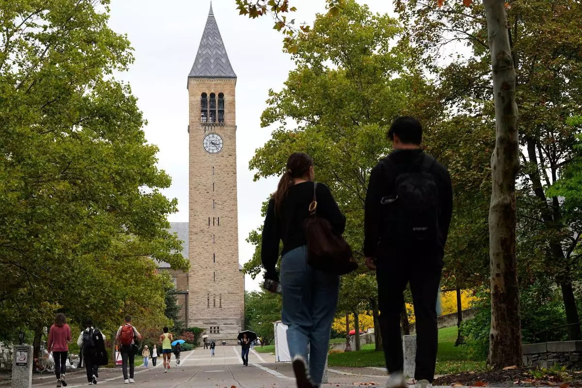 Pedestrians walk on the campus at Cornell University in Ithaca, N.Y., Thursday, Oct. 1, 2026. (AP Photo/Matt Rourke)