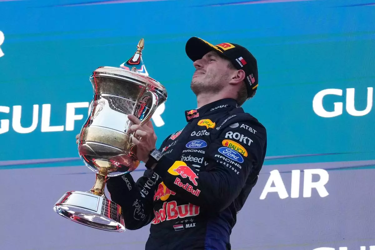 Red Bull driver Max Verstappen of the Netherlands celebrates on the podium after winning the Bahrain Grand Prix in Sepang, Malaysia, Sunday, Oct. 4, 2026. (AP Photo/Aijaz Rahi)