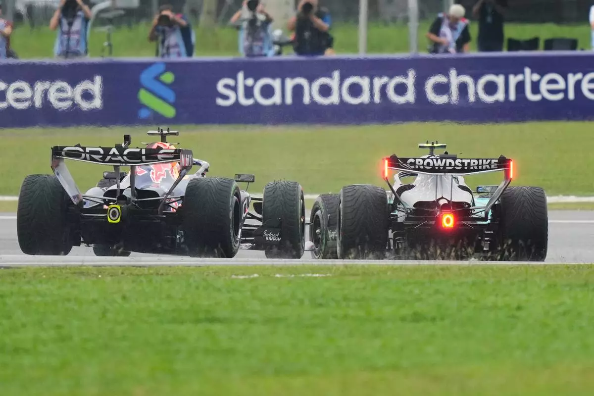 Red Bull driver Max Verstappen of the Netherlands tries to overtake Mercedes driver Andrea Kimi Antonelli of Italy steers his car during the Bahrain Grand Prix in Sepang, Malaysia, Sunday, Oct. 4, 2026. (AP Photo/Aijaz Rahi)