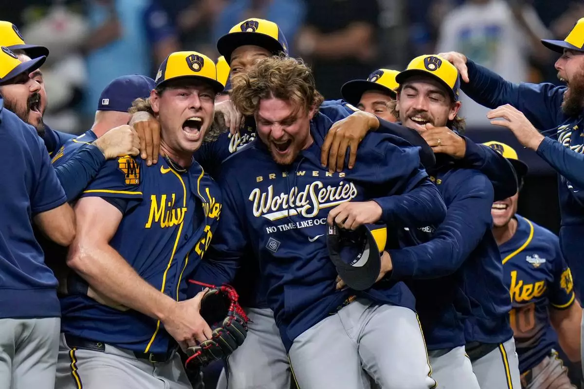 Milwaukee Brewers pitcher Trevor Megill, left, celebrates with teammates after winning baseball's World Series, against the Tampa Bay Rays, Wednesday, Oct. 28, 2026, in St. Petersburg, Fla.(AP Photo/Chris O'Meara)