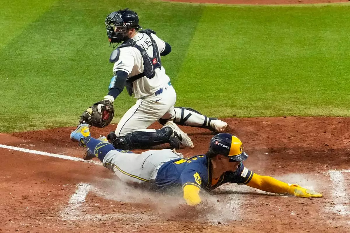 Milwaukee Brewers' William Contreras after scores past Tampa Bay Rays catcher Liam Hicks during the sixth inning of Game 5 of baseball's World Series, Wednesday, Oct. 28, 2026, in St. Petersburg, Fla., between the Milwaukee Brewers and the Tampa Bay Rays. (AP Photo/Ashley Landis)