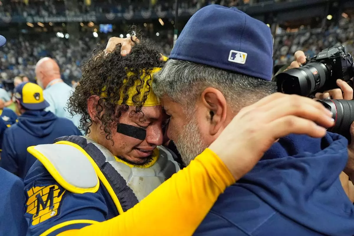 Milwaukee Brewers catcher William Contreras celebrates with manager Pat Murphy after their win against the Tampa Bay Rays in baseball's World Series, Wednesday, Oct. 28, 2026, in St. Petersburg, Fla. (AP Photo/Ashley Landis)