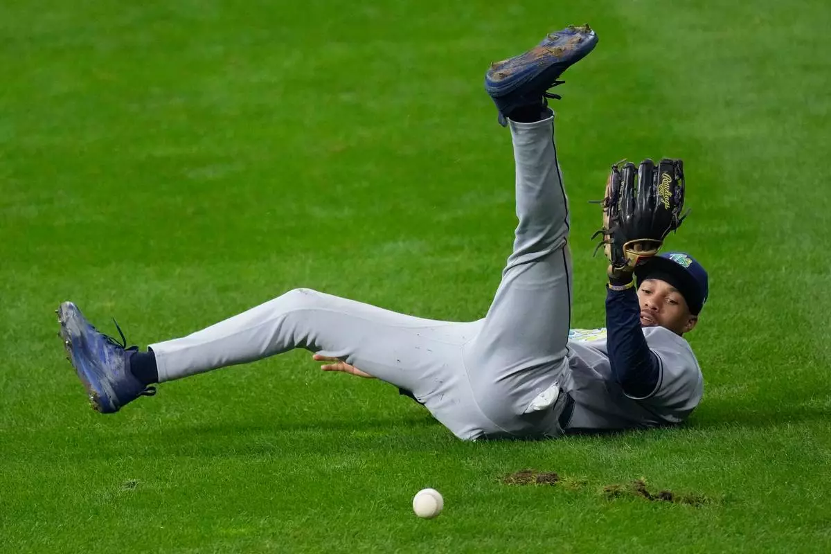 Tampa Bay Rays left fielder Chandler Simpson fails to catch a fly ball hit by Milwaukee Brewers' Christian Yelich during the sixth inning of Game 2 of baseball's World Series, Saturday, Oct. 24, 2026, in Milwaukee, between the Milwaukee Brewers and the Tampa Bay Rays. (AP Photo/David J. Phillip)