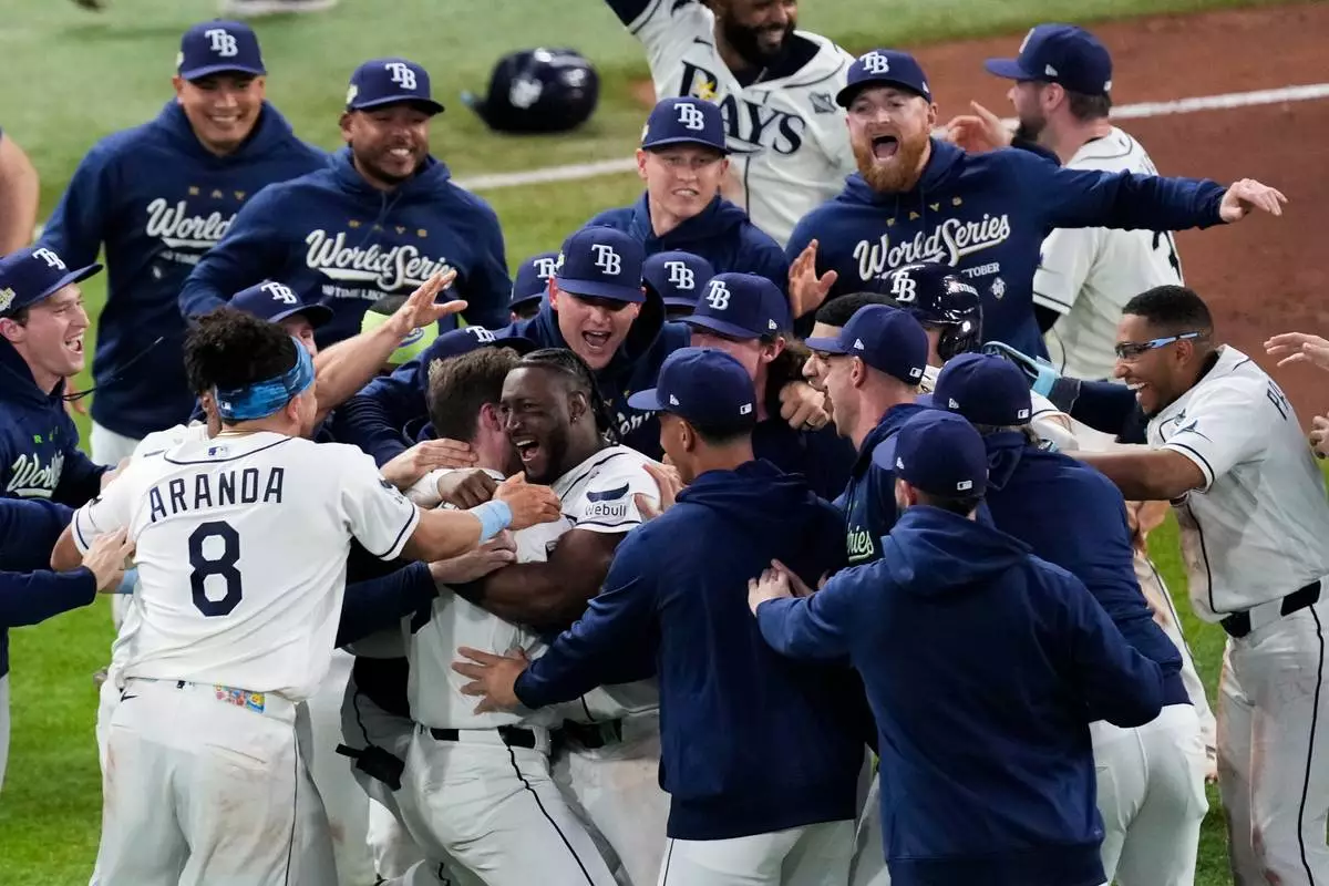 The Tampa Bay Rays celebrate their win after the 12th inning of Game 4 of baseball's World Series, Wednesday, Oct. 28, 2026, in St. Petersburg, Fla., between the Milwaukee Brewers and the Tampa Bay Rays. (AP Photo/Morry Gash)