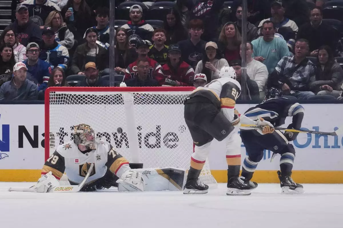 Vegas Golden Knights goaltender Carter Hart (79) watches as the puck enters the goal on a shot from Columbus Blue Jackets defenseman Denton Mateychuk, right, during the first period of an NHL hockey game Saturday, Oct. 24, 2026, in Columbus, Ohio. (AP Photo/Joshua A. Bickel)