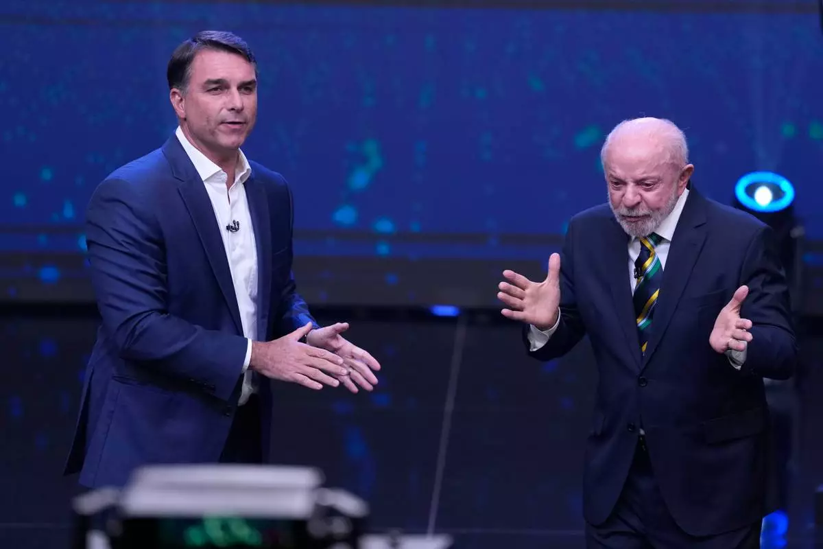 FILE - Brazil President Luiz Inacio Lula da Silva, right, who is running for reelection, gestures as opposition presidential candidate Sen. Flavio Bolsonaro stands beside him during a televised presidential debate one week before the runoff election in Sao Paulo, Brazil, Oct. 18, 2026. (AP Photo/Andre Penner, File)