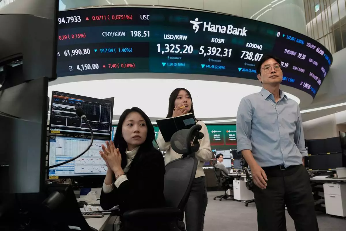 Currency traders work at the foreign exchange dealing room of the Hana Bank headquarters in Seoul, South Korea, Friday, Oct. 23, 2026. (AP Photo/Ahn Young-joon)