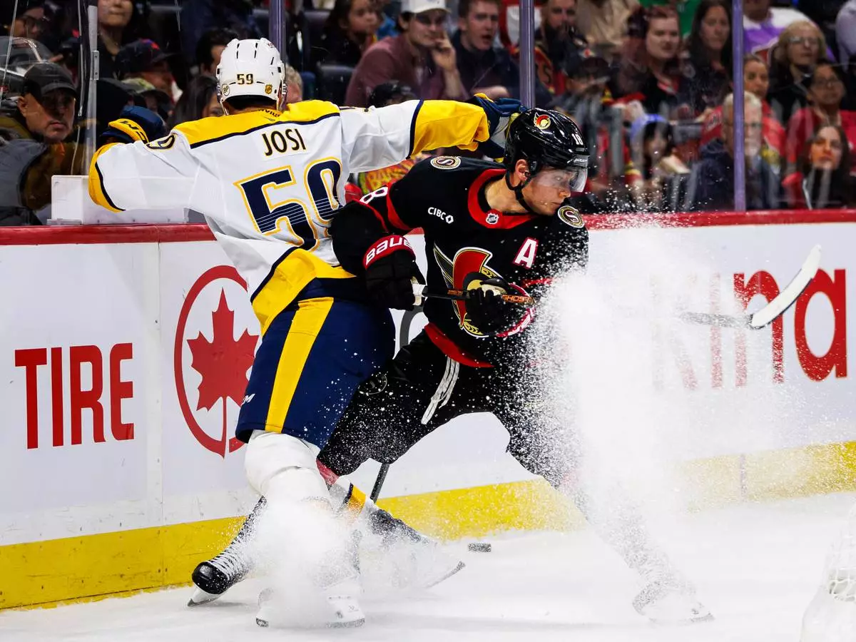 Ottawa Senators' Tim Stutzle (18) vies for the puck against Nashville Predators' Roman Josi (59) during second period of an NHL hockey game in Ottawa, Ontario, Saturday, Oct. 10, 2026. (Keito Newman/The Canadian Press via AP)