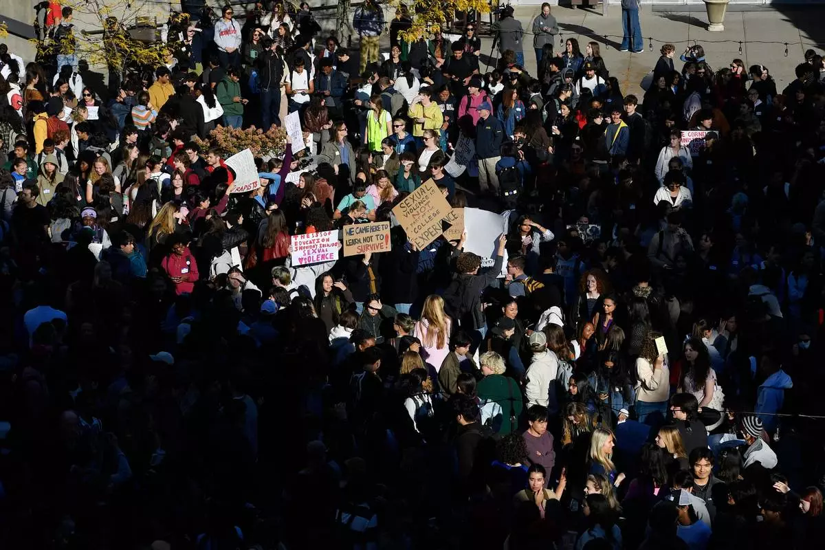 Demonstrators attend a protest against Cornell University's handling of the 2024 fraternity-house gang rape allegations at the campus, Monday, Oct. 5, 2026, in Ithaca, N.Y. (AP Photo/Adrian Kraus)