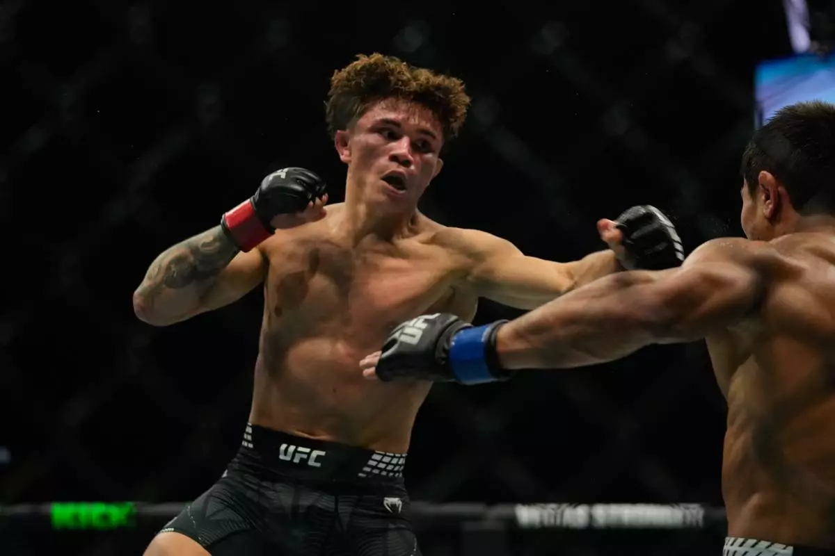 Lone'er Kavanagh of Britain, left, punches Uzbekistan's Ramazan Temirov, during flyweight bout at the mixed martial arts UFC Fight Night on Saturday, Oct. 24, 2026. (AP Photo/Altaf Qadri)
