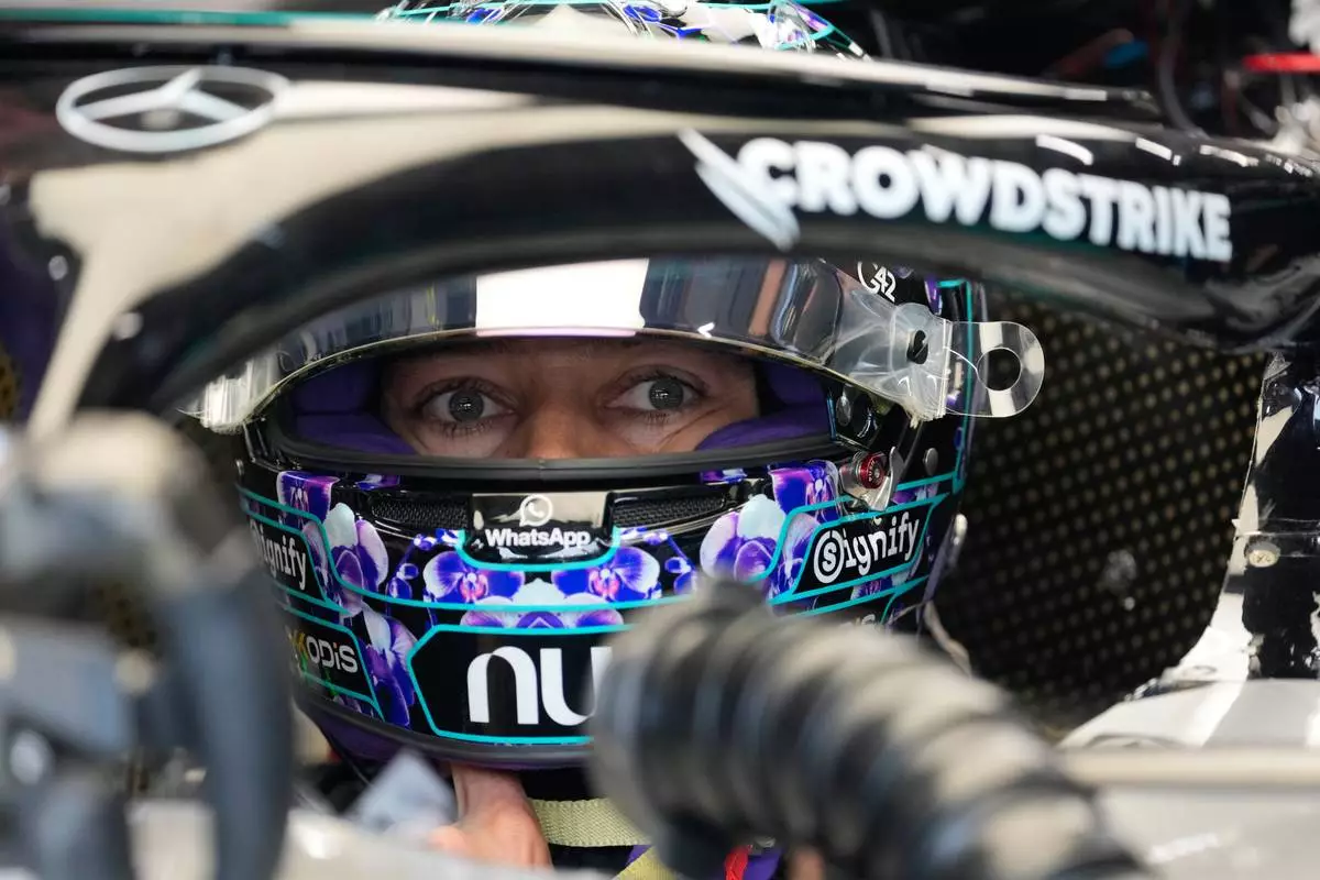 Mercedes driver George Russell, of Britain, sits on his car at pits before the first free practice ahead of the Singapore Formula One Grand Prix, in Singapore, Friday, Oct. 9, 2026. (AP Photo/Vincent Thian)