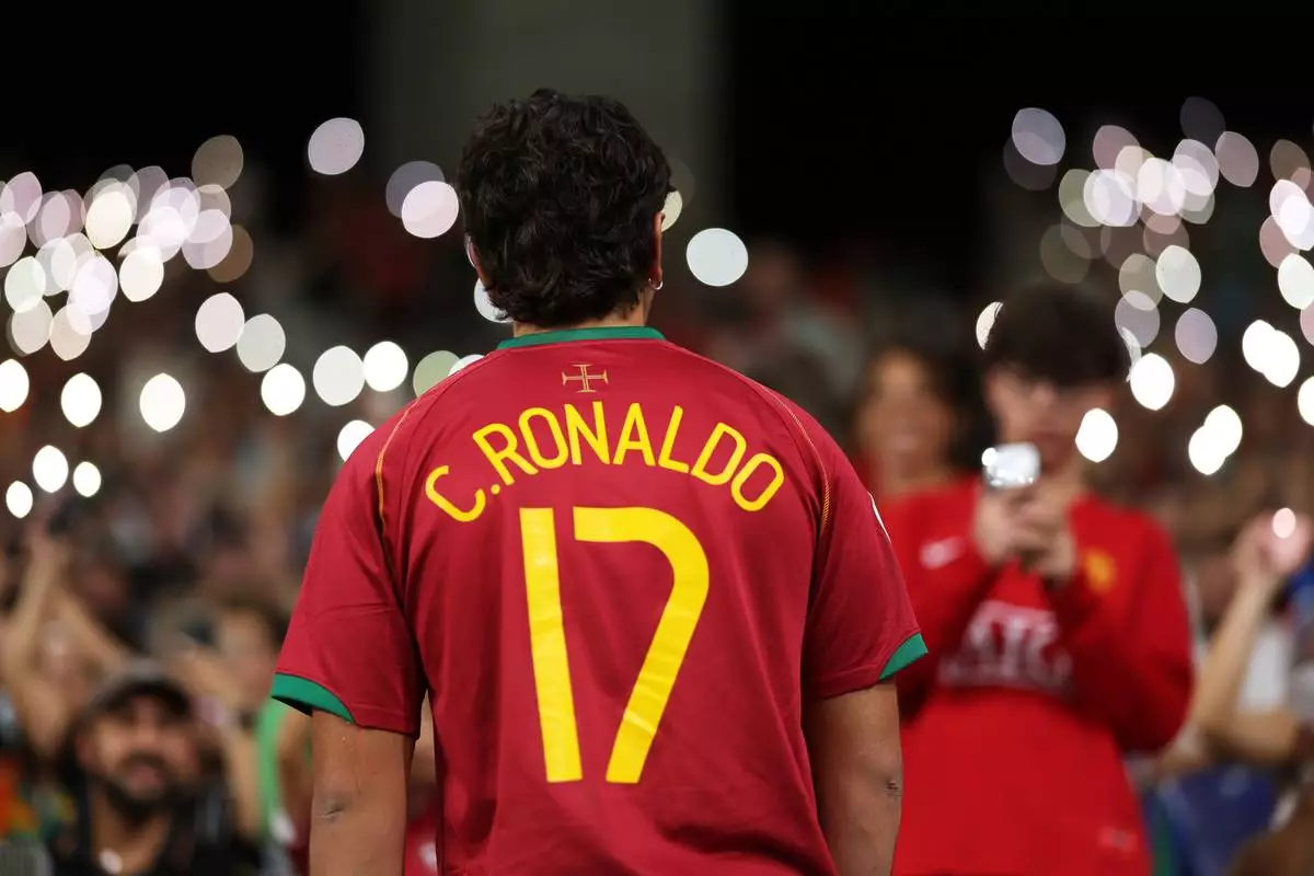 A fan pose wearing Portugal's Cristiano Ronaldo shirt on the stands during halftime of the Nations League soccer match between Portugal and Norway in Porto, Portugal, Sunday, Oct. 4, 2026. (AP Photo/Luis Vieira)