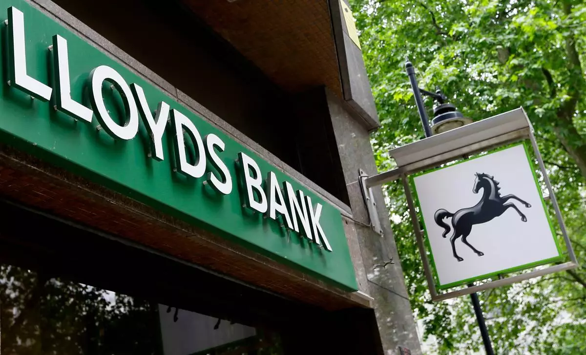 FILE - In this Friday, June 5, 2015 file photo, a sign for the Lloyds Bank is seen at a branch in London. (AP Photo/Kirsty Wigglesworth, file)