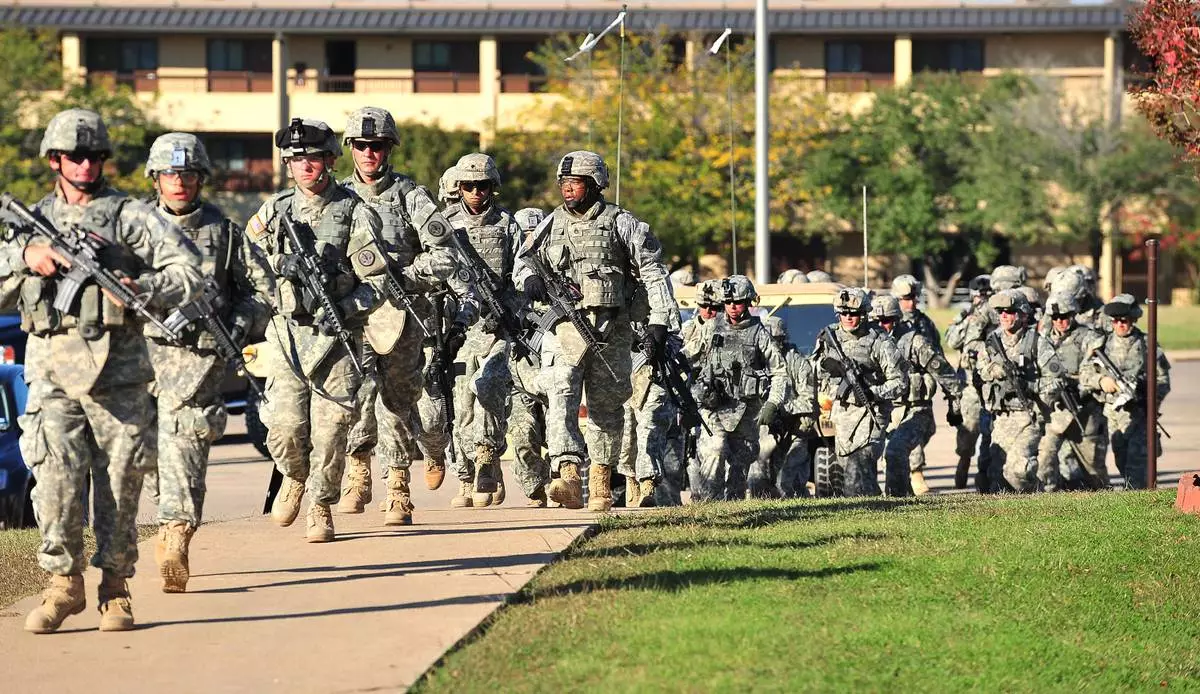 FILE - Soldiers from the 3rd Armored Cavalry Regiment storm the grounds of the Soldier Readiness Center to apprehend a mass shooter in Fort Hood, Texas, on Nov. 5, 2009. (David Morris/Killeen Daily Herald via AP, File)