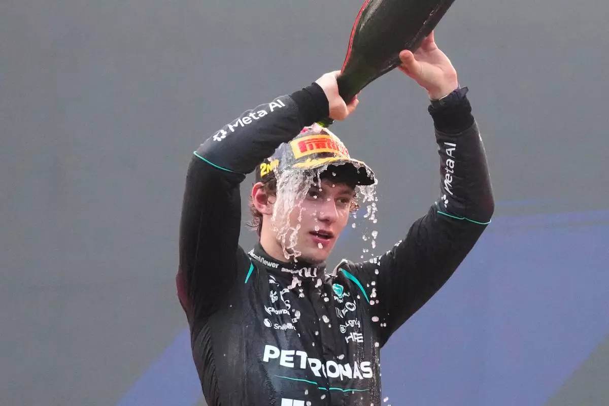 Mercedes driver Andrea Kimi Antonelli of Italy celebrates his second place on the podium the Bahrain Grand Prix in Sepang, Malaysia, Sunday, Oct. 4, 2026. (AP Photo/Aijaz Rahi)