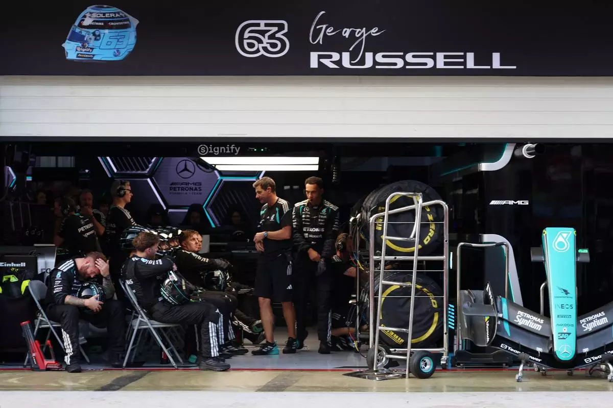 Mercedes crew members for driver George Russell of Britain react inside the garage during the Bahrain Grand Prix in Sepang, Malaysia, Sunday, Oct. 4, 2026. (Annice Lyn/Pool via AP )
