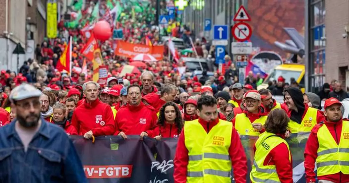 Police and masked protesters clash in Brussels as anti-austerity rally disrupts city