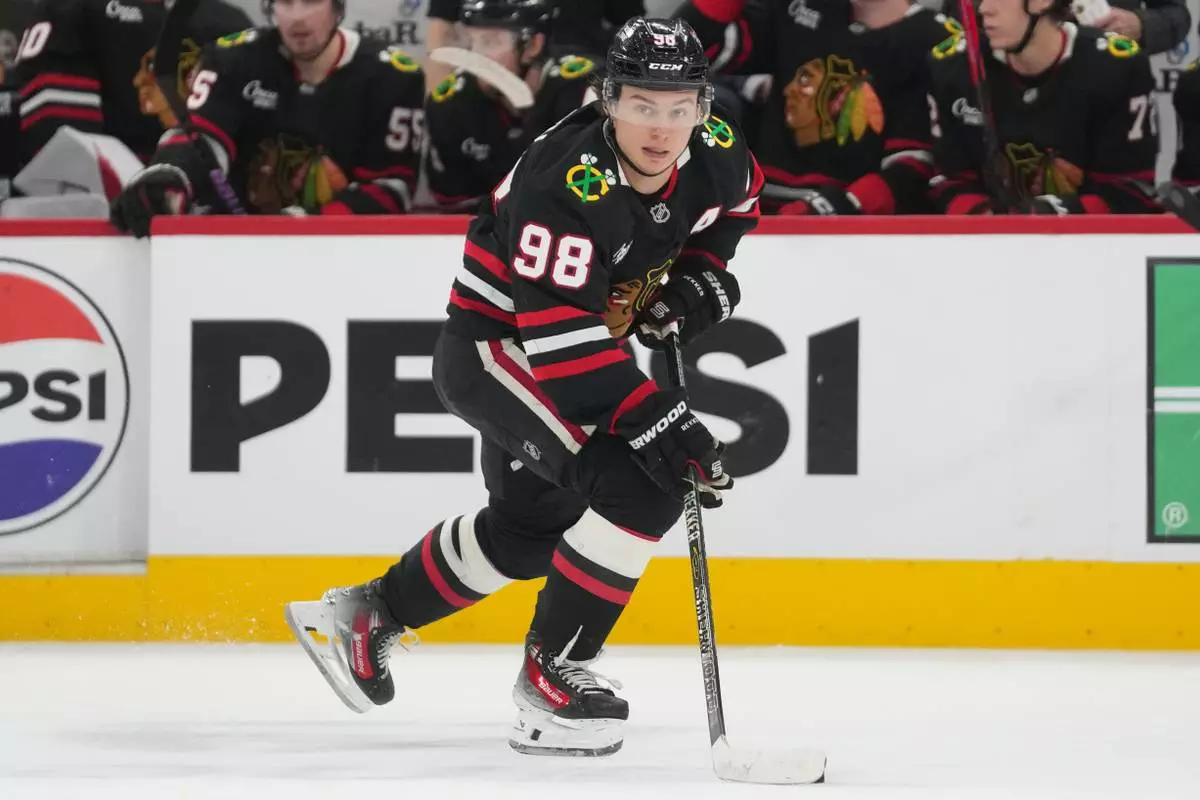 FILE - Chicago Blackhawks center Connor Bedard handles the puck during the second period of an NHL hockey game against the Colorado Avalanche, March 20, 2026, in Chicago. (AP Photo/Erin Hooley, File)