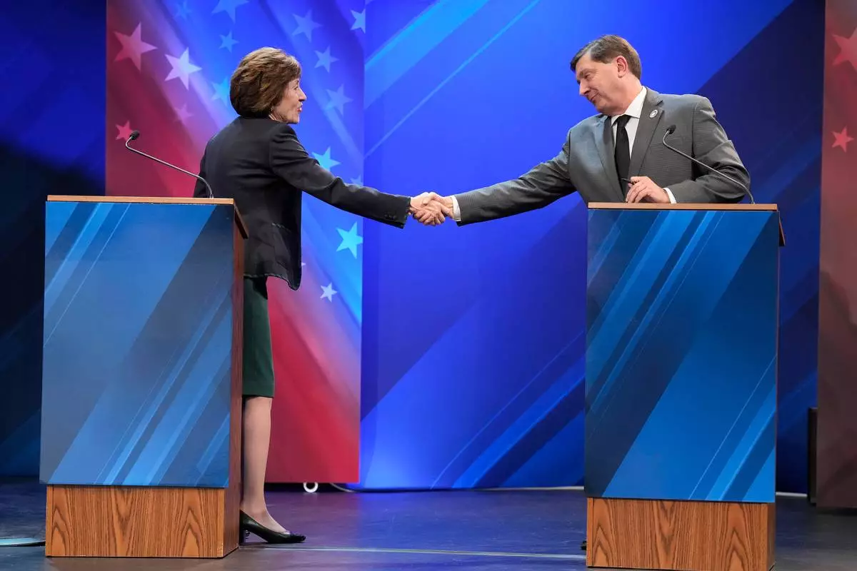 Sen. Susan Collins (R) and Troy Jackson (D) shake hands at the end of the final Maine U.S. Senate debate in Bangor, Maine, Thursday, Oct. 15, 2026. (Gregory A. Rec/Portland Press Herald via AP, Pool)