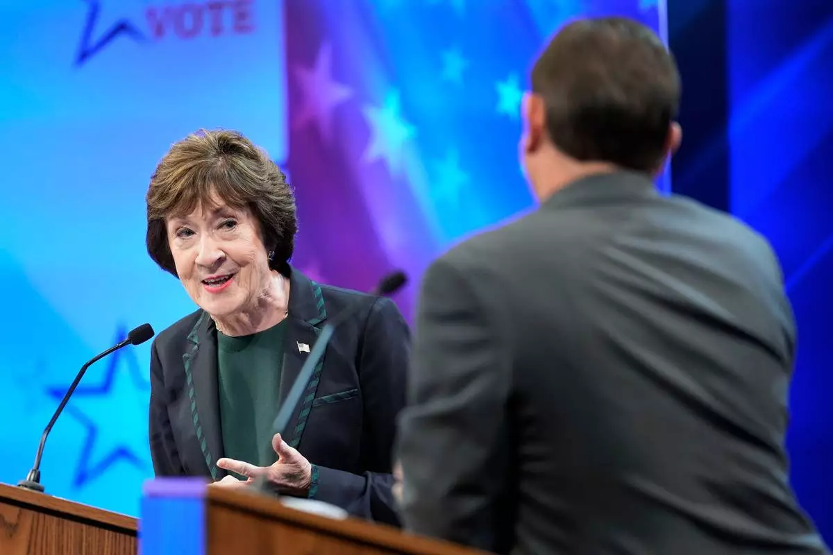Sen. Susan Collins (R) looks to Troy Jackson (D) as he answers a question during the final Maine U.S. Senate debate in Bangor, Maine, on Thursday, Oct. 15, 2026. (Gregory A. Rec/Portland Press Herald via AP, Pool)