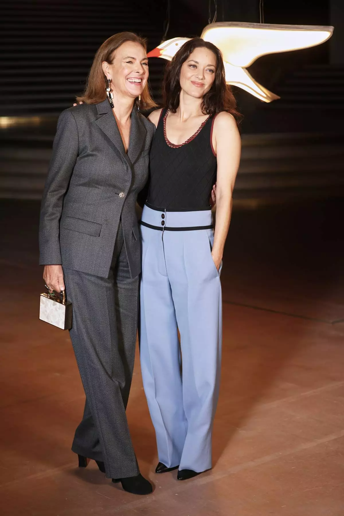 Carole Bouquet, left, and Marion Cotillard pose upon arrival at the Chanel Womenswear Spring Summer 2027 collection presented in Paris, France, Monday, Oct. 5, 2026. (AP Photo/Thomas Padilla)