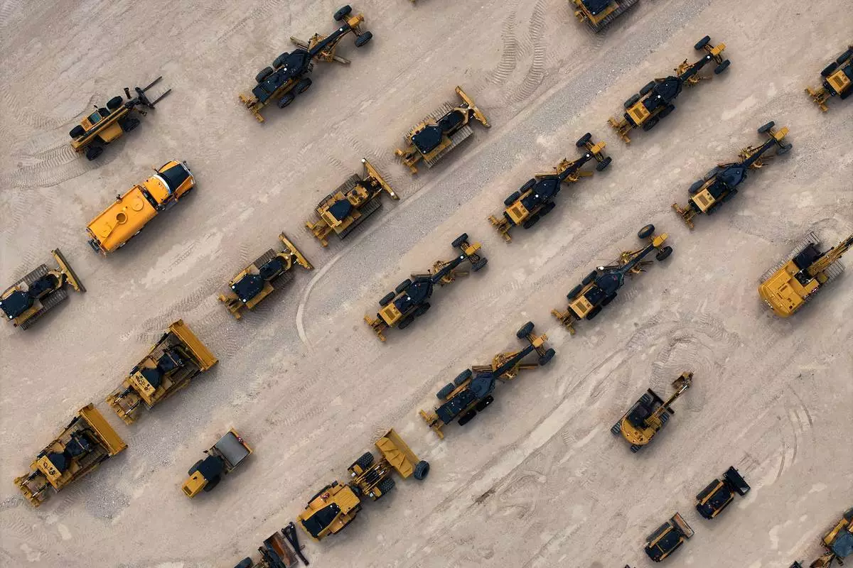 Heavy equipment and machinery intended for work on border barriers and roads are stored in a yard, Friday, Sept. 25, 2026, near Terlingua, Texas. (AP Photo/John Locher)