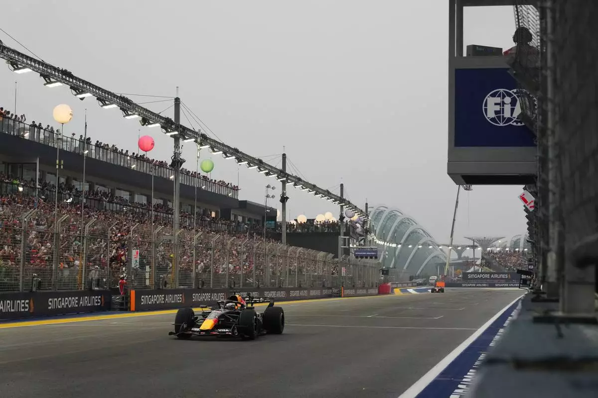 Red Bull driver Max Verstappen of the Netherlands crosses the finish line during the sprint race ahead of the Singapore Formula One Grand Prix in Singapore, Singapore, Saturday, Oct. 10, 2026. (AP Photo/Ng Han Guan, Pool)