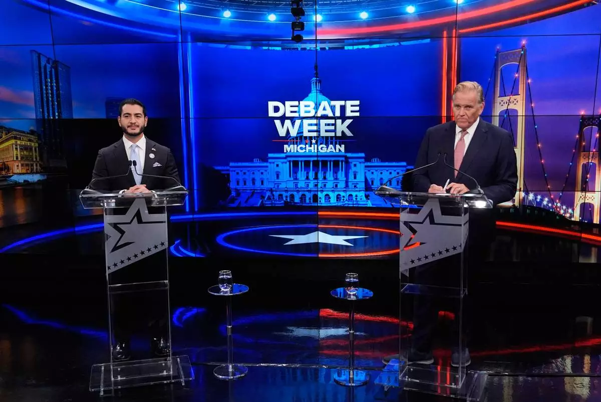 Democratic nominee for U.S. Senate Abdul El-Sayed, left, appears with Republican nominee for U.S. Senate Mike Rogers during a televised debate at WOOD-TV, on Thursday, Oct. 8, 2026, in Grand Rapids, Mich. (AP Photo/Paul Sancya, Pool)