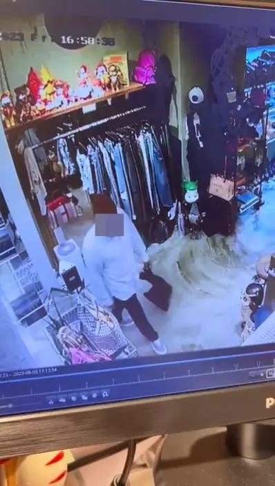 一名身穿白色長袖恤衫的南亞裔男子走入店內四處張望。