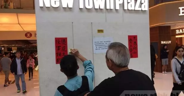 參與者在商場內的柱貼上揮春及文宣物品。（任順熙攝）