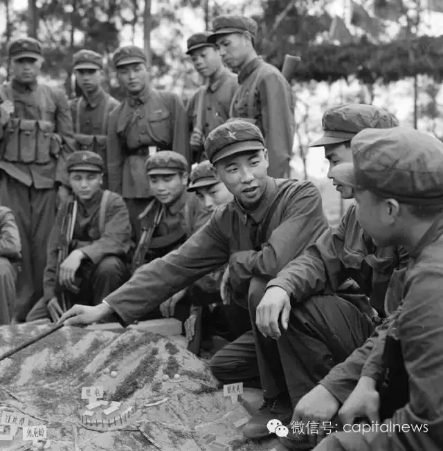 中越邊境自衛反擊戰，戰鬥英雄李作成（中間拿指揮棒者）給戰友們在沙盤上講解戰鬥方案。