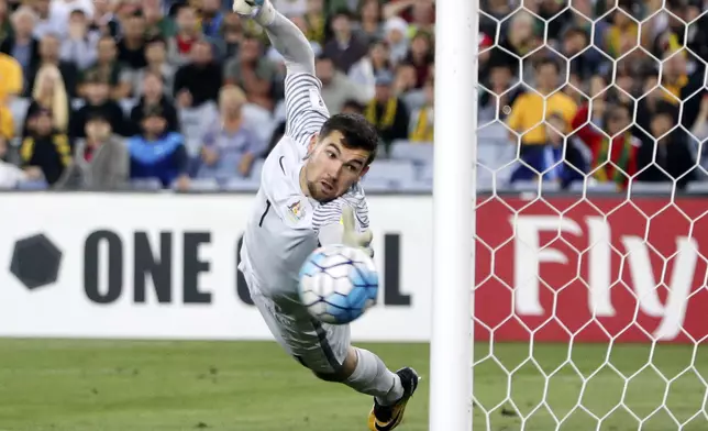 Australia's keeper Mathew Ryan dives at a ball that hit the post from a Syria free kick during their Soccer World Cup qualifying match in Sydney, Australia, Tuesday, Oct. 10, 2017. (AP Photo/Rick Rycroft)
