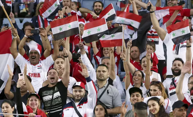 Syria fans cheer before the start of the Soccer World Cup qualifying match between Australia and Syria in Sydney, Australia, Tuesday, Oct. 10, 2017. (AP Photo/Rick Rycroft)