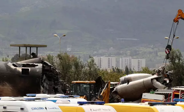 Ambulances park near two parts of the Algerian military plane after it crashed in Boufarik, near the Algerian capital, Algiers, Wednesday, April 11, 2018. Algerian emergency services say 181 people have been killed in a military plane crash and some survivors have been rescued. (AP Photo/Anis Belghoul)